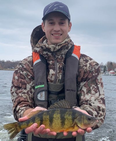 Tyler Hoyt displays a large yellow perch during fieldwork.